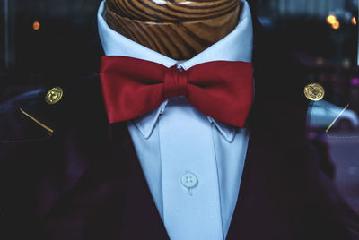 Close-up of red bow tie on mannequin at store window