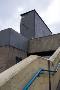 Low angle view of building against cloudy sky