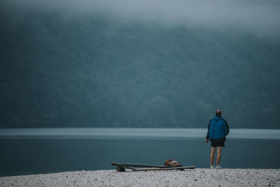 Rear view of man looking at sea