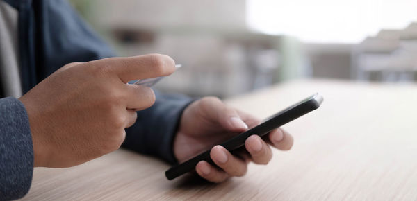 Close-up of man using mobile phone