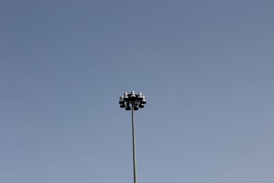 Low angle view of floodlight against clear blue sky