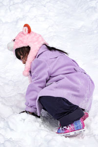 High angle view of girl with snow on land
