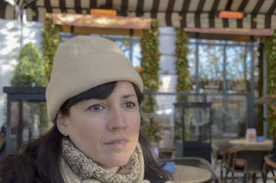 Close-up of mid adult woman sitting at sidewalk cafe