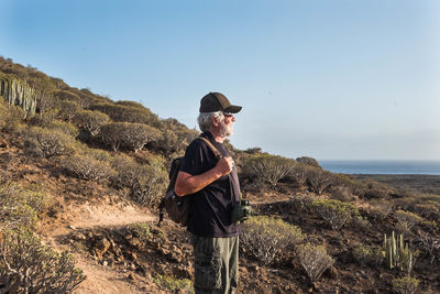 Full length of man standing on land against sky