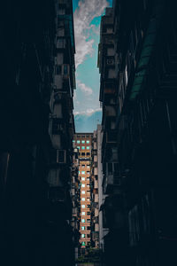 Low angle view of illuminated buildings against sky