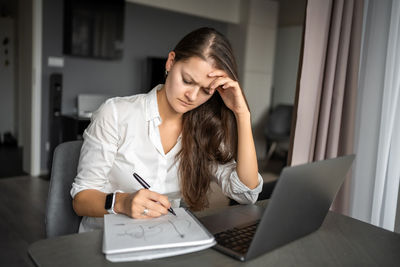 Businesswoman working at table