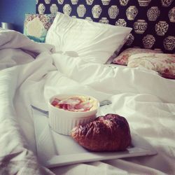 Close-up of cupcakes on bed at home