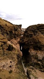 Low angle view of rock formation against sky