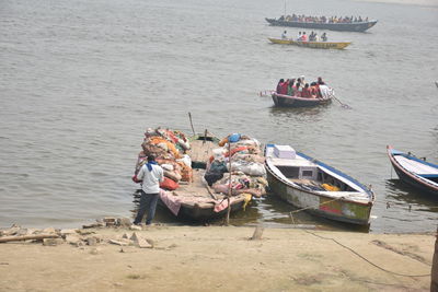 People sitting on boat moored in sea