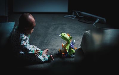 Boy sitting on table at home