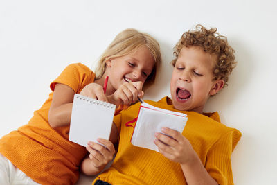 Portrait of boy with gift box against white background