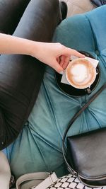 Low section of woman holding coffee