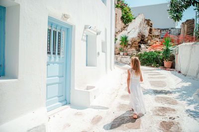 Woman standing at entrance of building