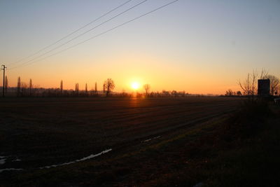 Scenic view of field against sky during sunset