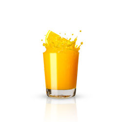 Close-up of yellow glass against white background