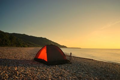 Scenic view of beach against sky during sunrise