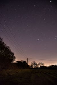 Scenic view of field against star field at night