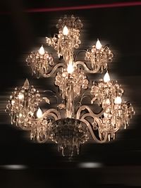 Low angle view of illuminated chandelier in darkroom