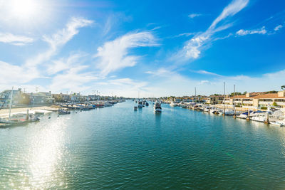 Panoramic view of marina bay against blue sky