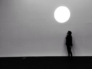 Optical illusion of woman looking at spotlight