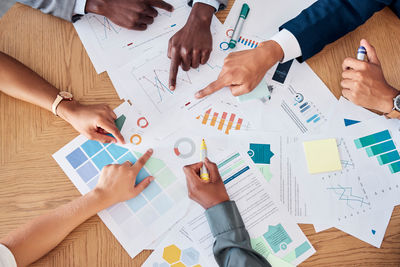 Midsection of business colleagues working on table