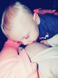 Close-up of baby sleeping in bed