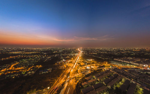 High angle view of illuminated buildings against sky during sunset