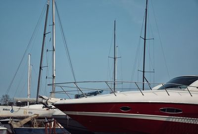 Boats moored in water against clear sky