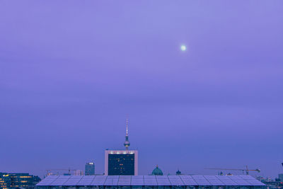 Low angle view of buildings against sky at night