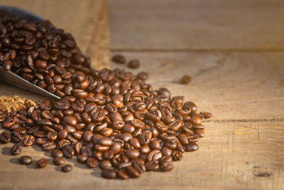 Close-up of roasted coffee beans on table