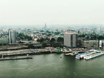 Scenic view of river and buildings against clear sky