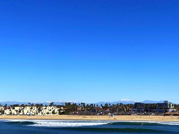 View of beach with city in background