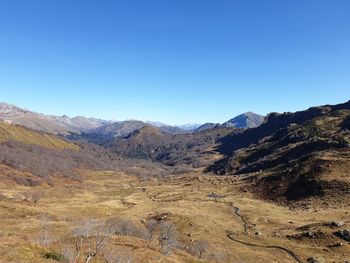 Scenic view of mountains against clear blue sky