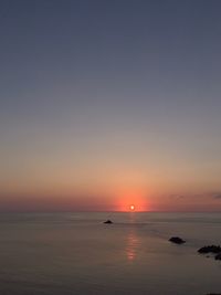 Scenic view of sea against clear sky during sunset