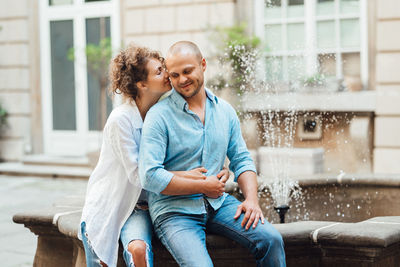 Young couple sitting outdoors