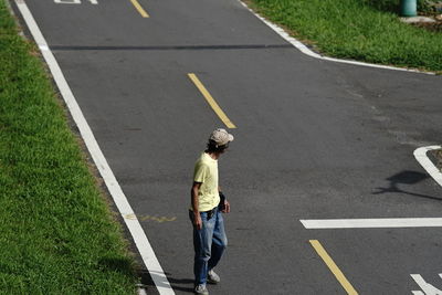 High angle view of man walking on road