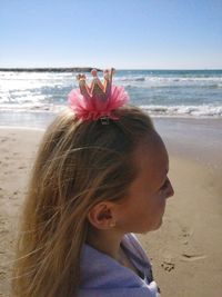 Close-up of woman on beach against clear sky