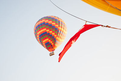 Low angle view of balloons against sky