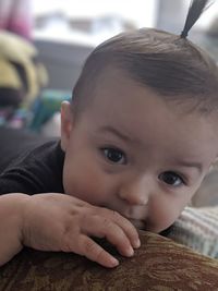 Close-up portrait of cute baby girl at home