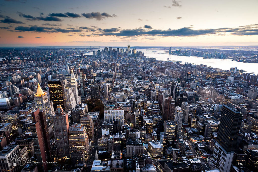 cityscape, city, architecture, building exterior, built structure, crowded, water, sea, skyscraper, sky, high angle view, horizon over water, tower, modern, tall - high, capital cities, travel destinations, aerial view, office building, sunset