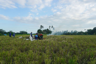 People on field against sky