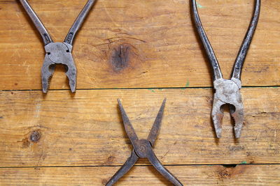 High angle view of pliers on wooden table