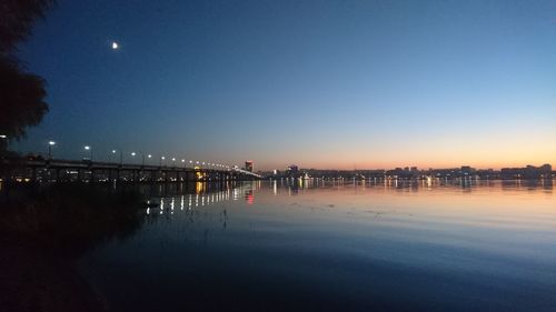 Scenic view of illuminated city against clear sky at night