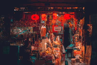 Illuminated lanterns hanging in store for sale at market stall