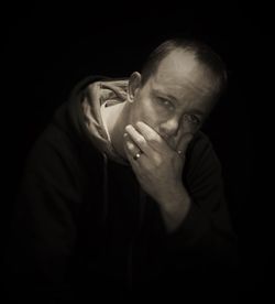 Portrait of thoughtful man in darkroom