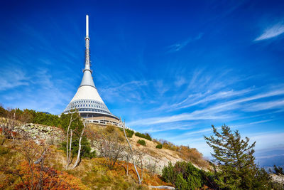 Low angle view of tower against cloudy sky