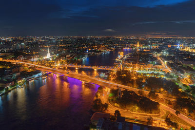 High angle view of illuminated buildings in city at night