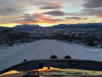 Scenic view of snow covered mountains against sky during sunset