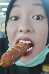 Close-up portrait of girl eating ice cream