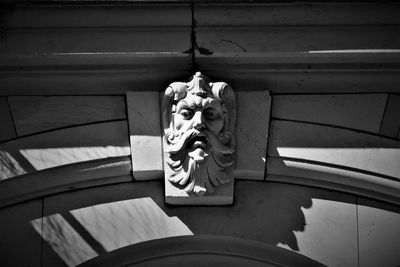 Low angle view of statue against building